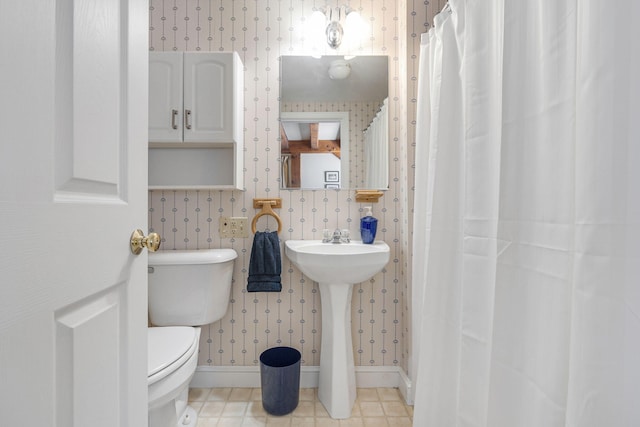 bathroom with toilet and tile flooring