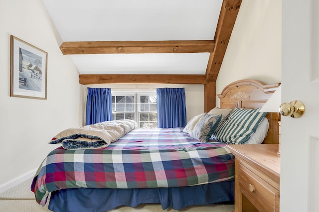 bedroom with vaulted ceiling with beams and carpet floors