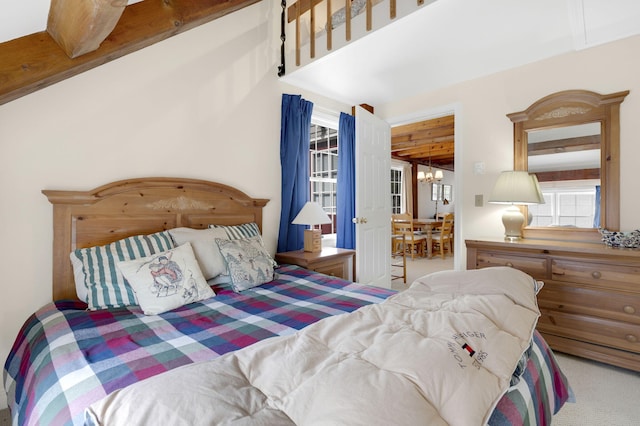 carpeted bedroom with an inviting chandelier