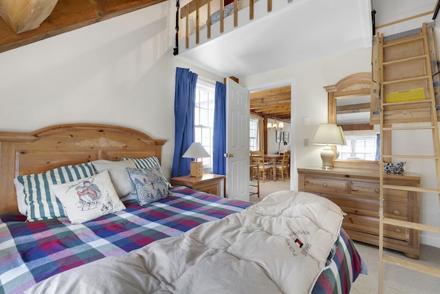 bedroom with light carpet and a chandelier