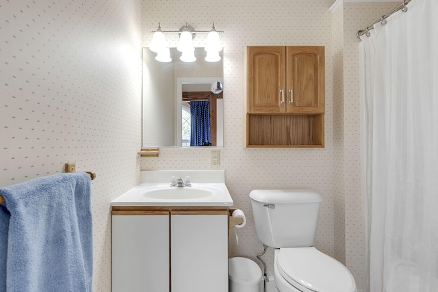 bathroom with toilet and vanity