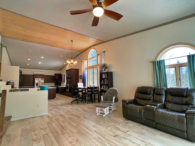 living room featuring ornamental molding, lofted ceiling, light wood-type flooring, and ceiling fan with notable chandelier