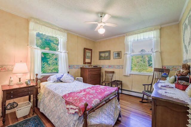 bedroom with a textured ceiling, wood-type flooring, ceiling fan, ornamental molding, and a baseboard heating unit