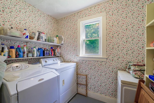 clothes washing area featuring baseboards, laundry area, and washer and dryer