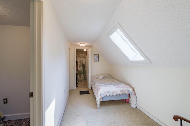 carpeted bedroom with vaulted ceiling and a textured ceiling