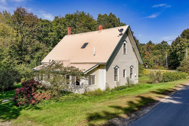 view of property exterior featuring a yard