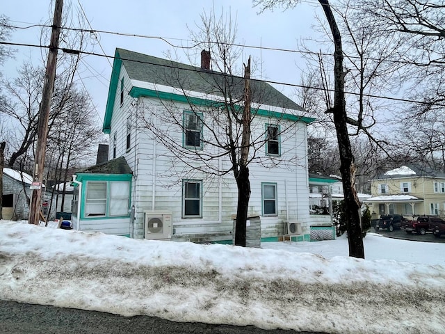 view of snow covered rear of property