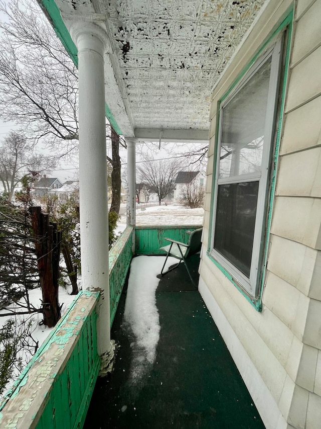 view of snow covered back of property