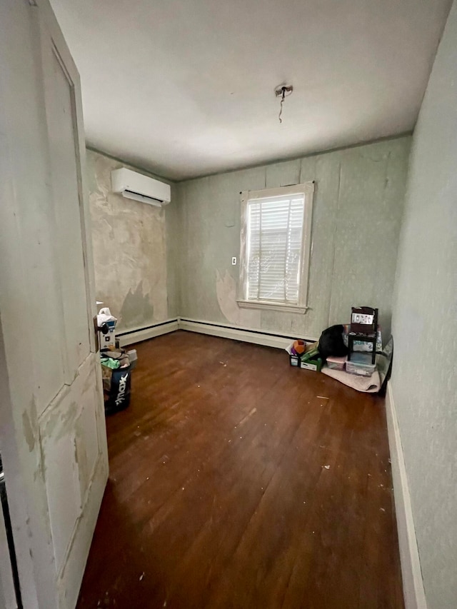 empty room with dark hardwood / wood-style flooring and a wall mounted AC