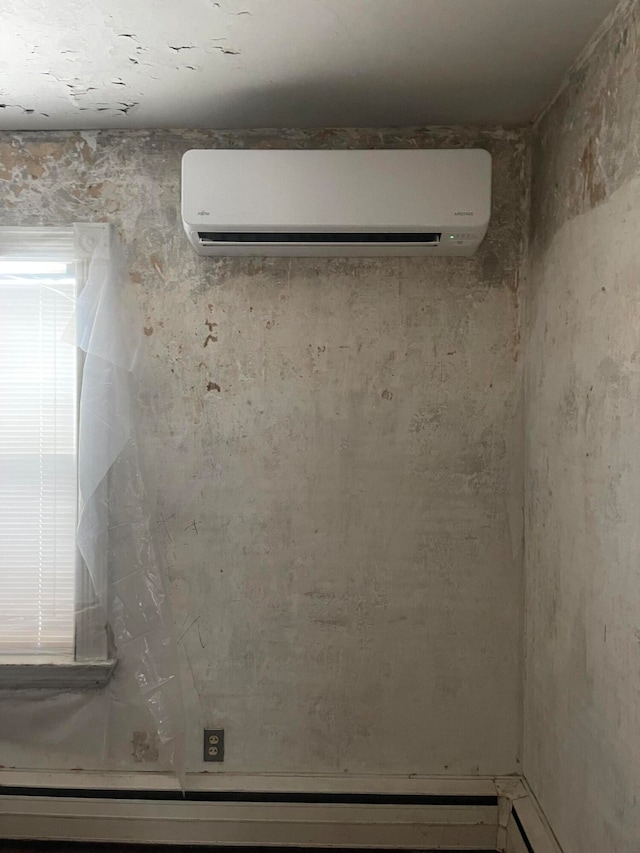 unfurnished room with an AC wall unit