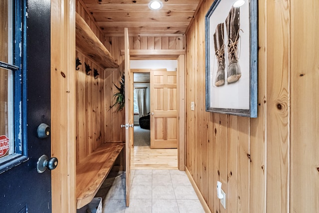 mudroom featuring light tile patterned floors, wood ceiling, and wooden walls