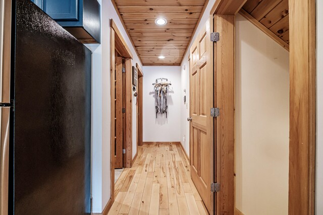 hallway featuring light wood-type flooring, wooden ceiling, baseboards, and recessed lighting