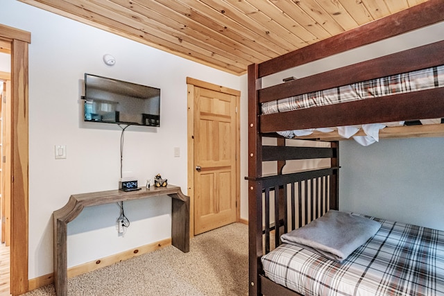 bedroom with carpet floors, wood ceiling, and baseboards