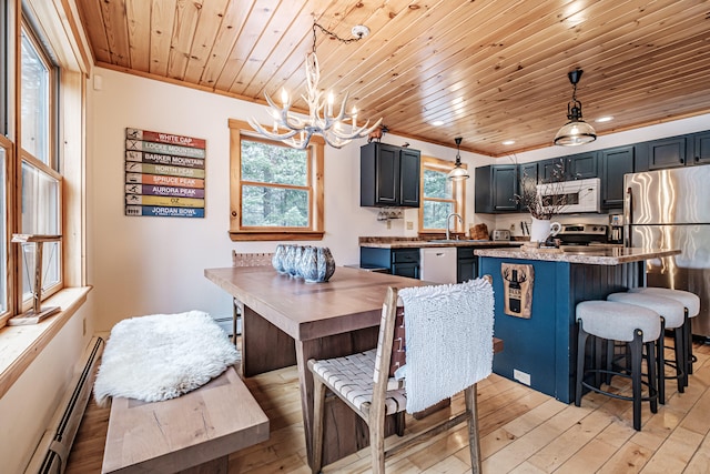 dining area with wood ceiling, light wood finished floors, a baseboard radiator, and a wealth of natural light