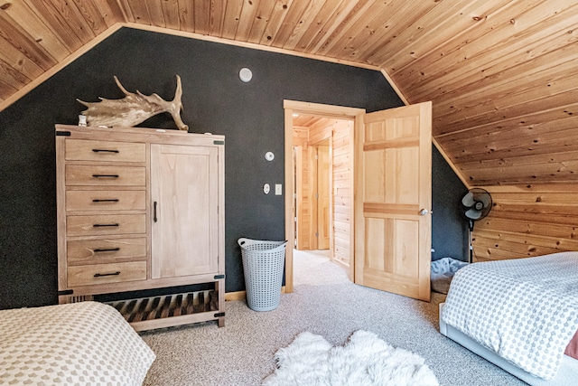 carpeted bedroom featuring vaulted ceiling and wood ceiling