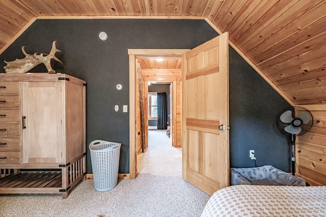 bedroom with lofted ceiling, wood ceiling, and light colored carpet