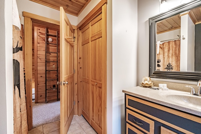 bathroom with wooden ceiling, tile patterned flooring, and vanity