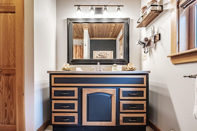 bathroom featuring baseboards and vanity