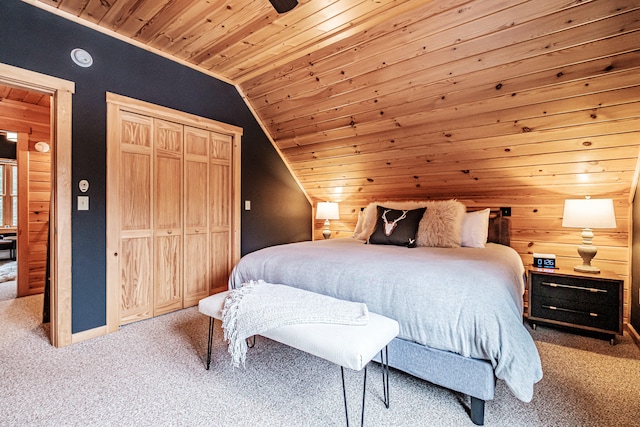 bedroom featuring carpet floors, wood ceiling, a ceiling fan, vaulted ceiling, and a closet