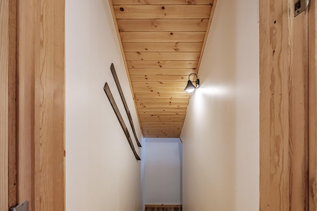 stairway with wooden ceiling