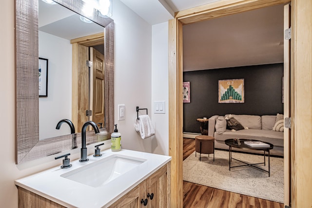 bathroom with a baseboard radiator, wood finished floors, and vanity