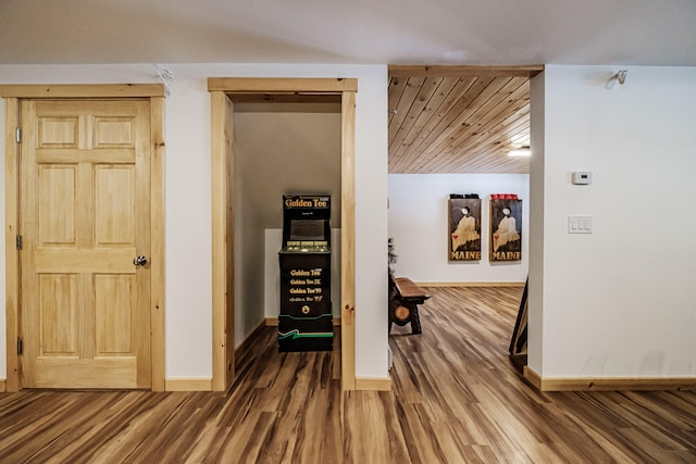 hall featuring baseboards and wood finished floors