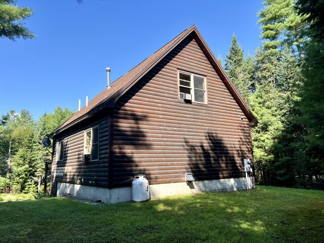 view of side of home with a yard