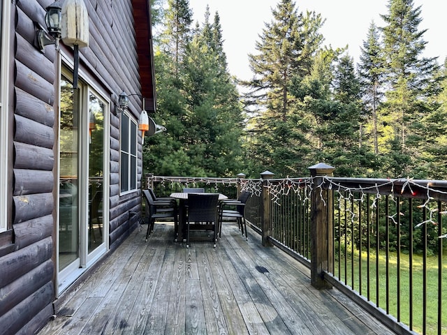 wooden terrace featuring outdoor dining space