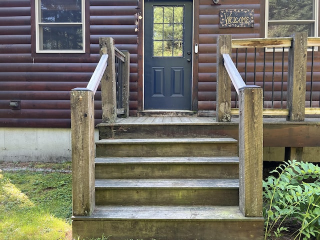 view of exterior entry with log veneer siding