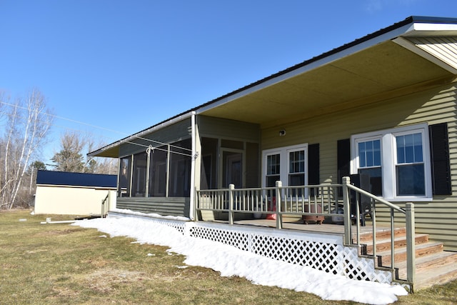 view of side of property with a deck and a sunroom