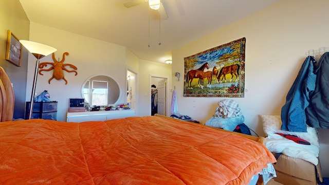 bedroom featuring a spacious closet, a closet, and ceiling fan