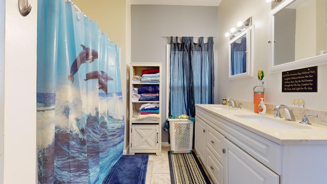 bathroom featuring tile flooring, dual sinks, and large vanity