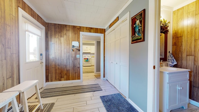 interior space featuring vanity, wood walls, and crown molding