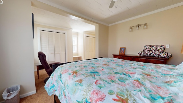 carpeted bedroom featuring ornamental molding and ceiling fan