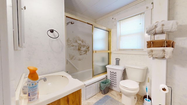 full bathroom featuring toilet, vanity, ornamental molding, combined bath / shower with glass door, and tile flooring