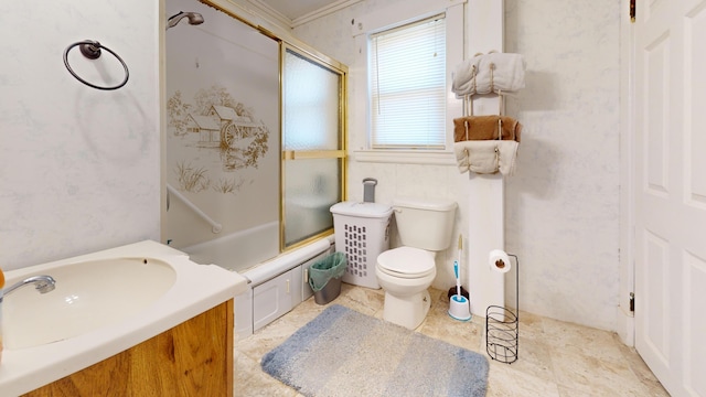 full bathroom featuring toilet, enclosed tub / shower combo, ornamental molding, tile floors, and vanity