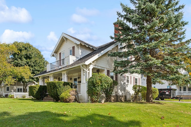 view of home's exterior with a porch and a lawn