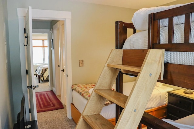 bedroom featuring light carpet