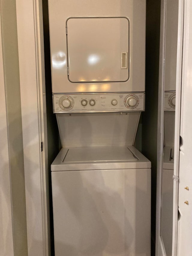 laundry room with stacked washer / dryer