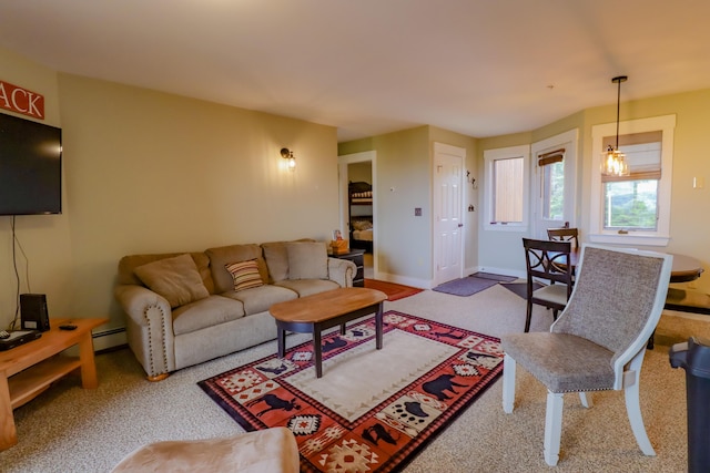 carpeted living room featuring a baseboard heating unit