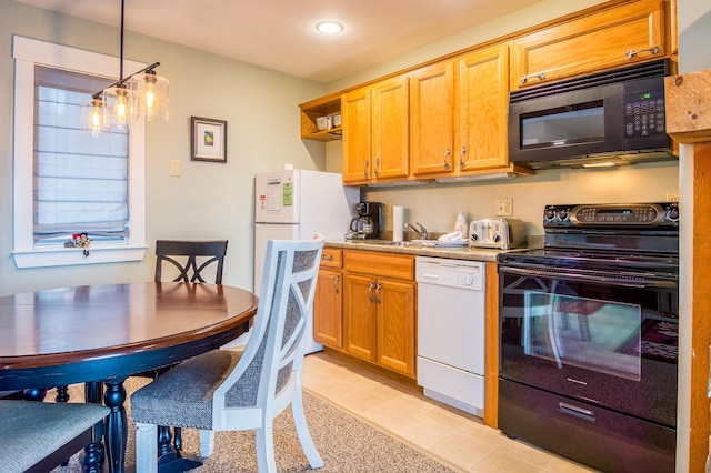 kitchen featuring pendant lighting, sink, and black appliances