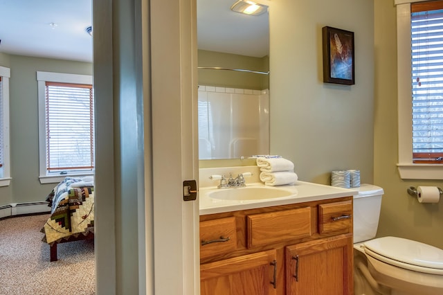 bathroom featuring vanity, toilet, and walk in shower