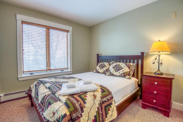 carpeted bedroom featuring a baseboard radiator