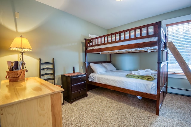 carpeted bedroom featuring a baseboard heating unit