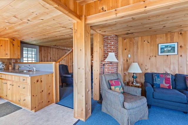 interior space with wooden ceiling, sink, brick wall, and wooden walls