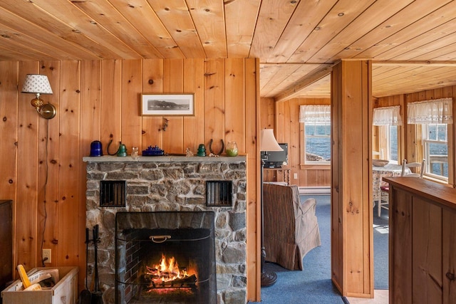 details with a fireplace, wood ceiling, carpet flooring, wooden walls, and a baseboard radiator