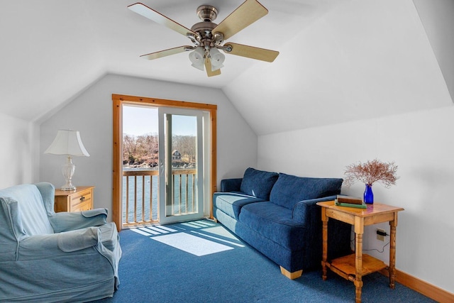 living room with dark colored carpet, ceiling fan, and lofted ceiling