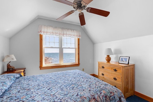 bedroom featuring lofted ceiling, ceiling fan, and a water view