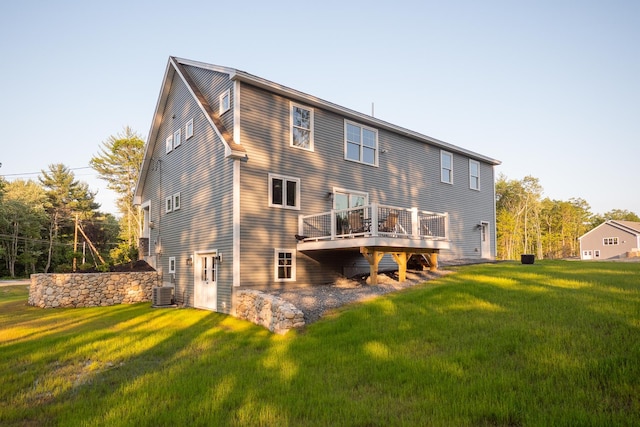 rear view of house with a lawn, central air condition unit, and a wooden deck