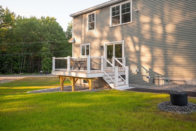 back of house with a lawn and a wooden deck